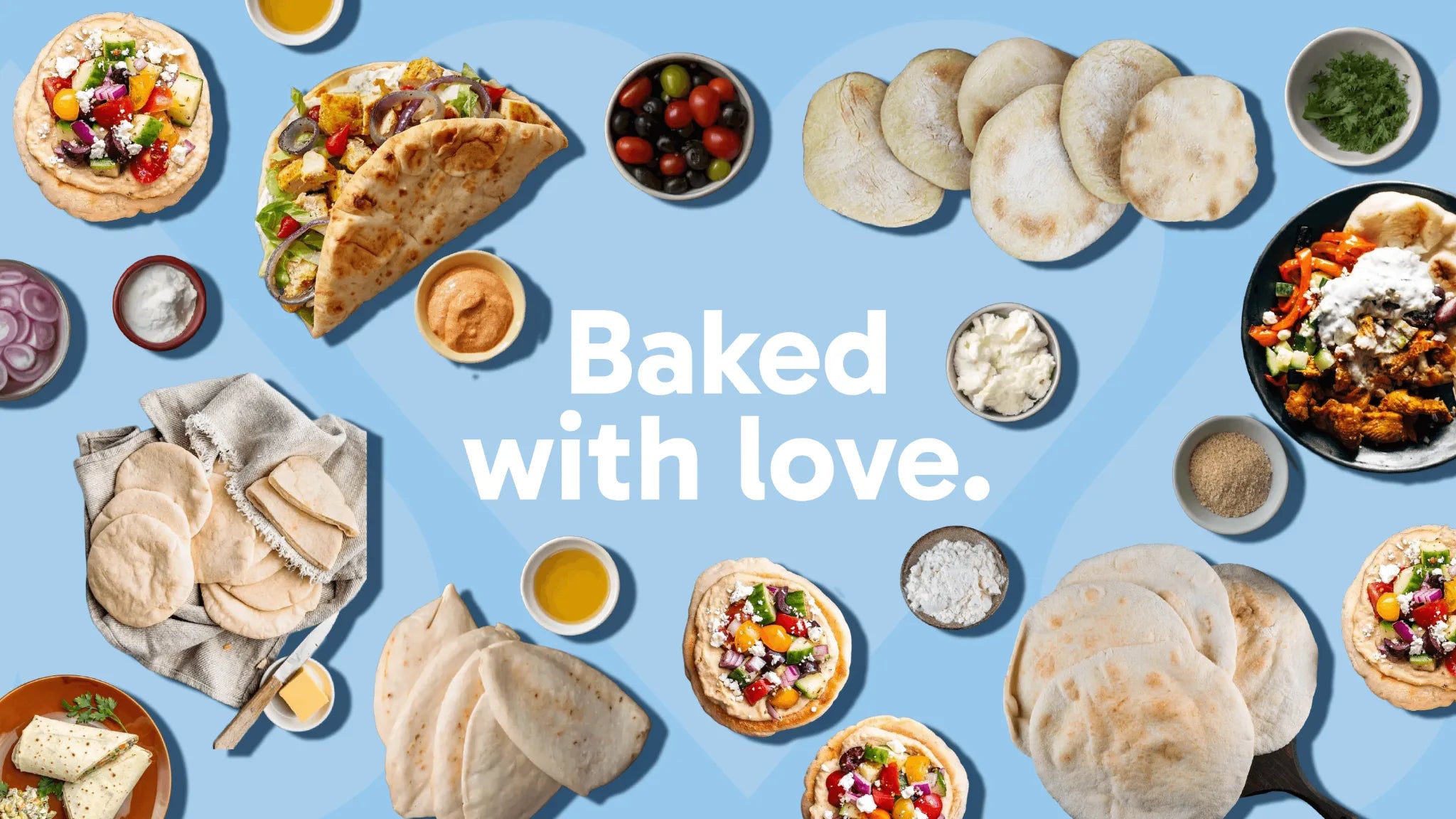 Assorted baked items including pita bread,  and bowls of toppings on a blue background with 'Baked with love.' text.